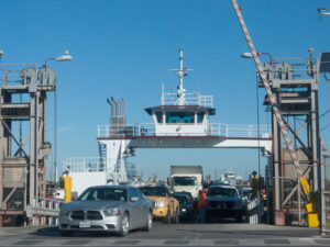 Cars driving off of the ferry