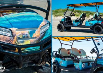 Beach buggy with turtle image on front and blue water and turtles on the side