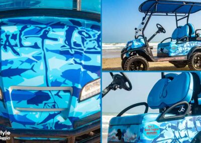 Golf cart with lots of fish in different colors of blue.